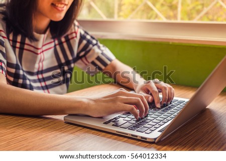 Put fingers on the keyboard of labtop vintage style.