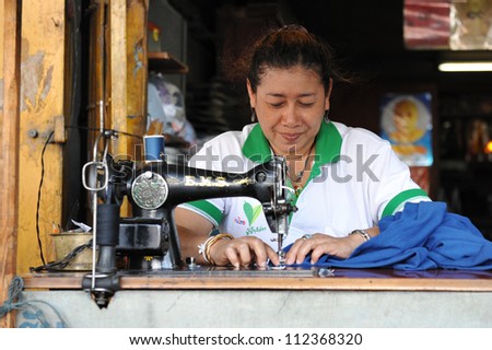 BANGKOK - JAN 11: An unidentified woman operates a sewing machine in a garments factory on Jan 11, 2011 in Bangkok, Thailand. Textile and clothing is Thailand's largest manufacturing industry.