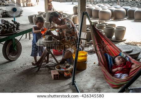 Vinh Long, Vietnam, September 27, 2015 the woman, traditional pottery, rural Vinh Long, Vietnam, the little ones