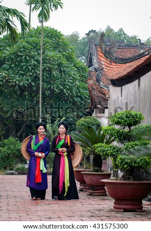 BAC Ninh, Vietnam, May 4, 2016 Two young girls, wearing traditional costumes, ancient temples roam, rural Bac Ninh, Vietnam