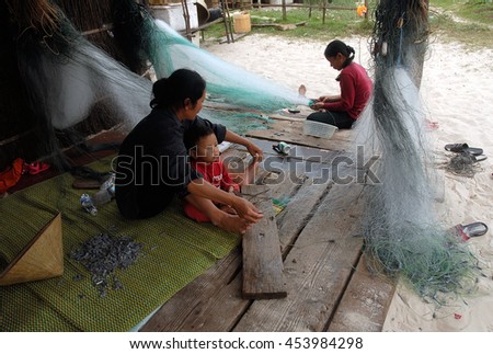 QUANG BINH, Vietnam, July 12, 2016 women, waters Quang Binh, Vietnam, sat knitting fishing nets