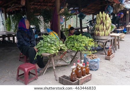 HOA BINH, Vietnam, March 12, 2016 Ethnic Thai woman, highland Hoa Binh, Vietnam, food products business, boiled corn. green vegetables