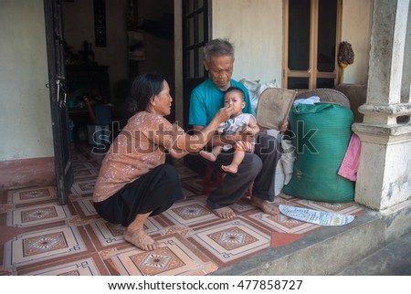HAI DUONG, Vietnam, August 26, 2016 grandparents, care, young nephew, a suburb of Hai Duong, Vietnam. their simple happiness
