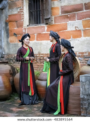 BAC Ninh, Vietnam, August 21, 2016 group of young women, Bac Ninh province, Vietnam. wearing traditional costumes. standing next to old temple
