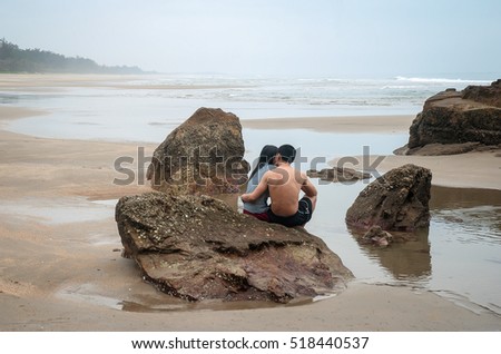 QUANG BINH, Vietnam, July 24, 2016 couple, sitting watching the sea, rocks, coastline Quang Binh, central Vietnam