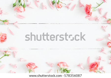 Spring flowers. Pink flowers on white wooden background. Flat lay, top view.