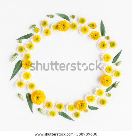 Flowers composition. Wreath made of various yellow flowers on white background. Spring, summer, easter concept. Flat lay, top view