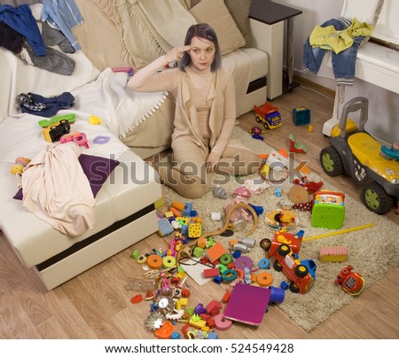 stock-photo-mother-sitting-on-the-couch-mom-tired-to-tidy-up-the-house-child-scattered-toys-children-s-room-524549428.jpg