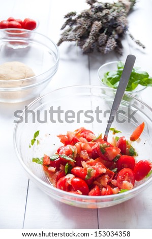 Cherry tomatoes with basil leaves and olive oil - stock photo