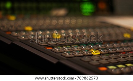 Blur image video switch of Television Broadcast, working with video and audio mixer, control broadcasts in recording studio. Broadcasting in the studio, professional mixing sender color buttons.