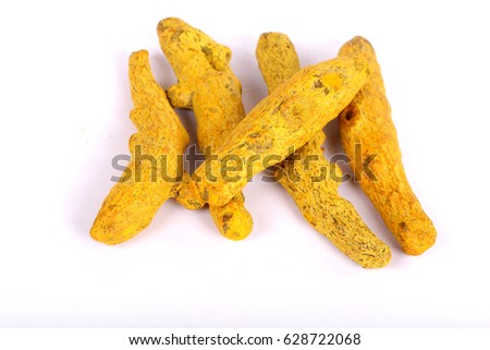 turmeric powder with fresh turmeric root in white