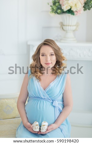 stock photo beautiful curly brunette young pregnant woman mother mom wearing fairy airy stylish blue dress 590198420
