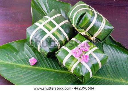 Uncooked Vietnamese Chung Cake isolated. It's a square glutinous sticky rice cake, stuffed with pork meat, green beans and wrapped in bamboo leaf. Traditional Vietnamese New Year (Tet) food.