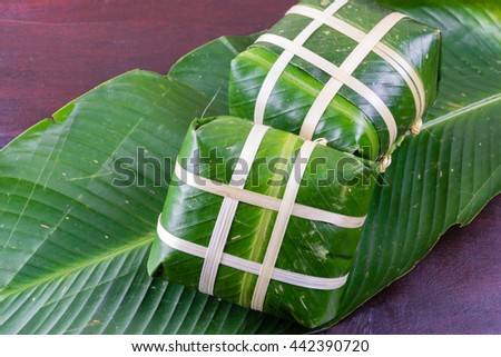 Uncooked Vietnamese Chung Cake isolated. It's a square glutinous sticky rice cake, stuffed with pork meat, green beans and wrapped in bamboo leaf. Traditional Vietnamese New Year (Tet) food.