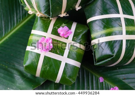 Uncooked Vietnamese Chung Cake isolated. It's a square glutinous sticky rice cake, stuffed with pork meat, green beans and wrapped in bamboo leaf. Traditional Vietnamese New Year (Tet) food.