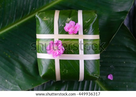 Uncooked Vietnamese Chung Cake isolated. It's a square glutinous sticky rice cake, stuffed with pork meat, green beans and wrapped in bamboo leaf. Traditional Vietnamese New Year (Tet) food.