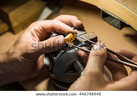 Craft jewelery making with professional tools. Ring repairing. Putting the diamond on the ring. Macro shot. A handmade jeweler process, manufacture of jewellery.
