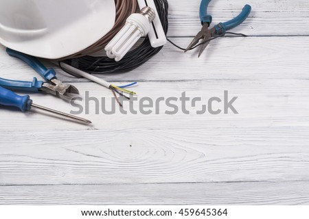 Set of electrical tool on wooden background. Accessories for engineering work, energy concept