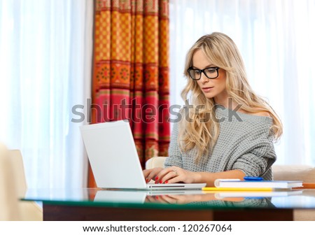 attractive woman writer in her home with laptop in creative process