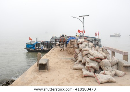 HAI PHONG, VIETNAM April 12 2016 Fishermen are transporting construction materials on Hon Dau Island.this is one of the most beautiful island and there are many tourists in Hai Phong,VIetnam