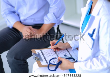 Doctor woman sitting with male patient at the desk