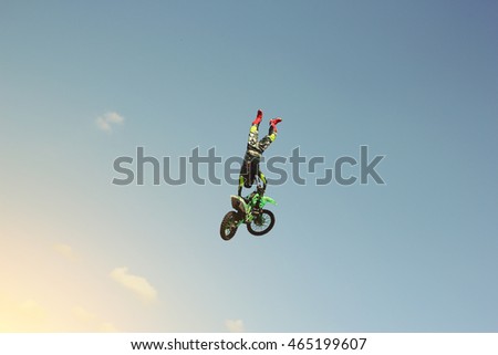 Biker stuntman doing a stunt in the air