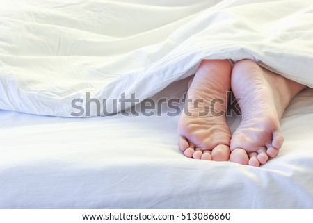 stock-photo-feet-of-sleeping-woman-in-white-bed-room-513086860.jpg