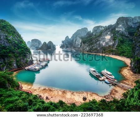 Tourist junks floating among limestone rocks at Ha Long Bay, South China Sea, Vietnam, Southeast Asia