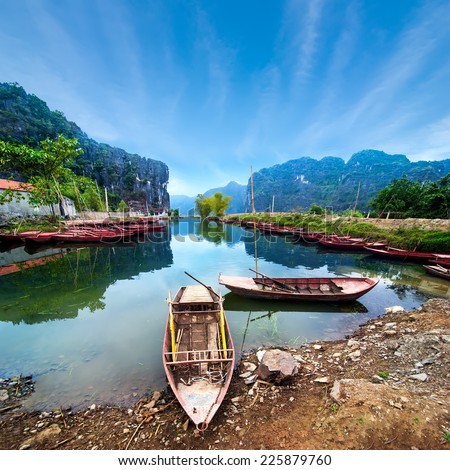Amazing morning view with Vietnamese boats at river. Tam Coc, Ninh Binh,. Vietnam travel landscape and destinations