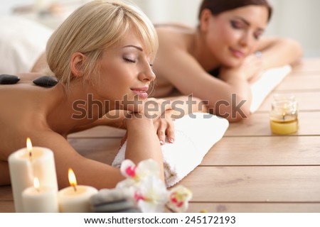 Two young beautiful women relaxing and enjoying at the spa