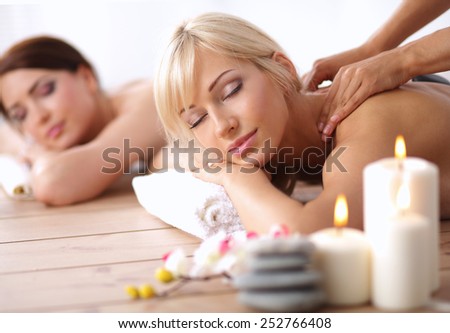 Two young beautiful women relaxing and enjoying at the spa