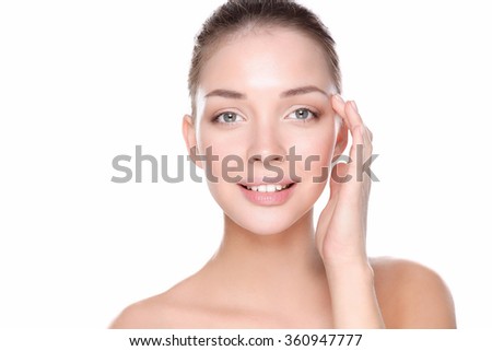 Beautiful healthy woman touching her skin