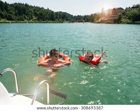 Kids Swimming In A Lake swimming lake stock images, royalty-free images & vectors Kids Swimming In A Lake swimming lake stock images, royalty-free images & vectors