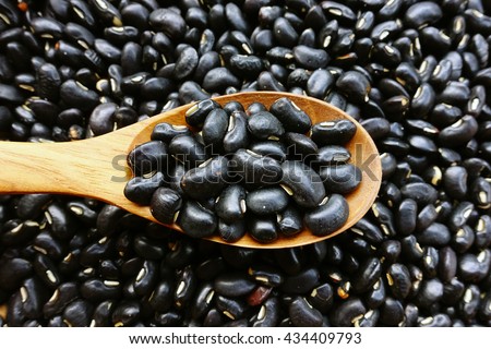 Black beans with a wooden spoon