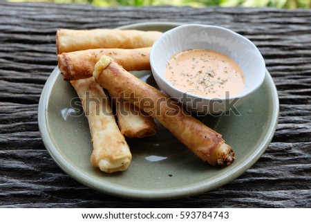 Ham cheese spring rolls on wooden table