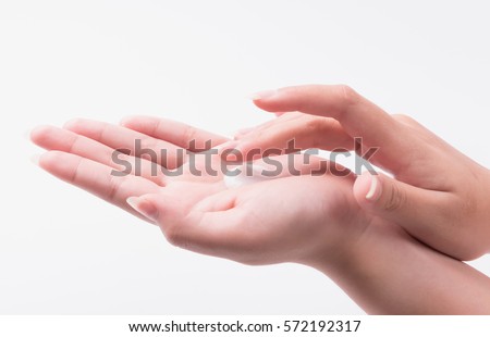 Young woman hand with lotion and cream on white.