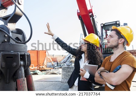 young female engineer talks about working with a worker