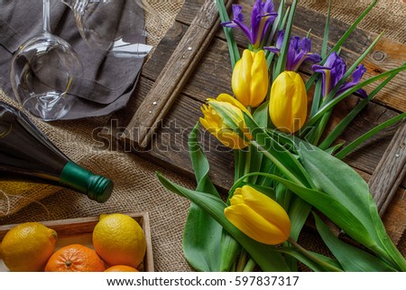 Easter Card In Rustic Style With Yellow Tulips Spring Iris Bottle Of White Wine Easter Card In Rustic Style With Yellow Tulips Spring Iris Bottle Of White Wine