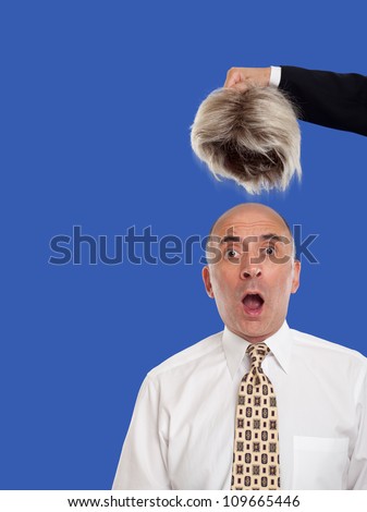 stock-photo-bald-man-revealed-by-removing-the-toupee-109665446.jpg