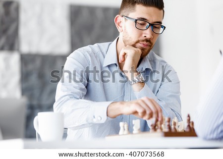 Portrait of two young man playing chess