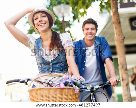 Happy couple in city with bike
