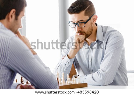 Portrait of two young man playing chess