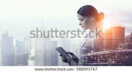 Attractive business lady working on tablet . Mixed media
