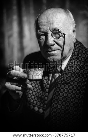 stock-photo-portrait-of-senior-man-with-monocle-and-a-coffee-cup-378775717.jpg