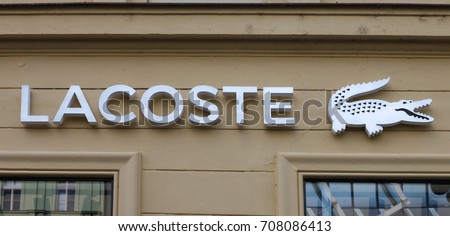Prague, Czech Republic - August 27, 2017: Lacoste sign on a store. Lacoste is a French clothing company that sells high-end clothing, footwear, perfume, leather goods, and most famously polo shirts