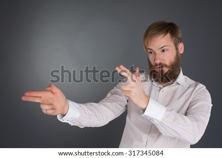 stock-photo-young-bearded-man-posing-pretending-shooting-with-finger-guns-317345084.jpg