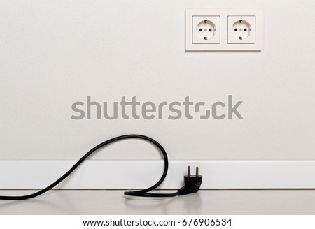 stock-photo-black-power-cord-cable-unplugged-with-european-wall-outlet-on-white-plaster-wall-with-copy-space-676906534.jpg