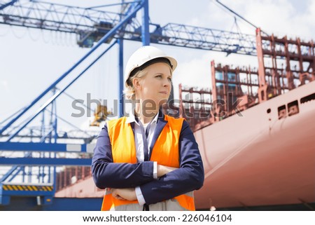 Confident female engineer in shipping yard