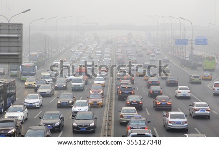 BEIJING, CHINA - DECEMBER 25, 2015: Traffic is seen at Guomao area in heavy smog. Today more than 200 flights were cancelled at the Beijing International Airport as heavy smog shrouded the city.