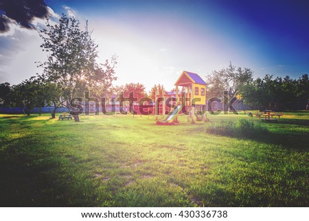 playground of children's near a house. vintage photo